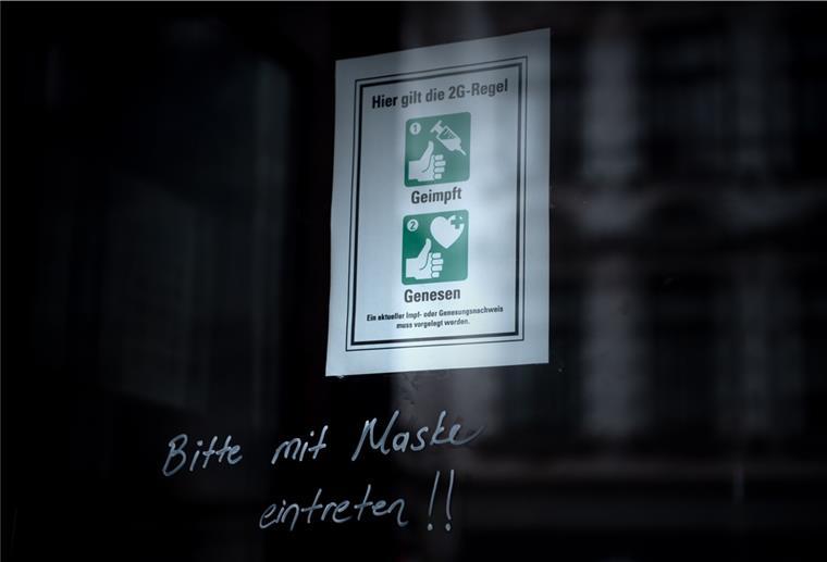 Ein Schild an der Eingangstür eines Geschäfts weist auf die 2G-Regel hin.
