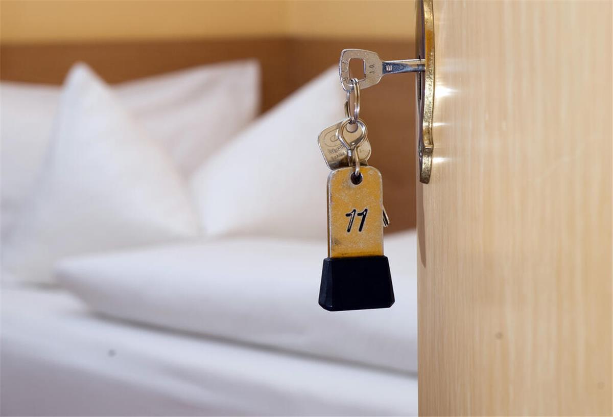 Dementer Mann schläft nächtelang neben toter Ehefrau ARCHIV - 28.11.2014, Niedersachsen, Goslar: ILLUSTRATION - Ein Zimmerschlüssel hängt in einem Gästehaus vor einem Bett im Türschloss. (zu dpa: «Umsatzeinbußen im Gastgewerbe») Foto: Swen Pförtner/dpa +++ dpa-Bildfunk +++