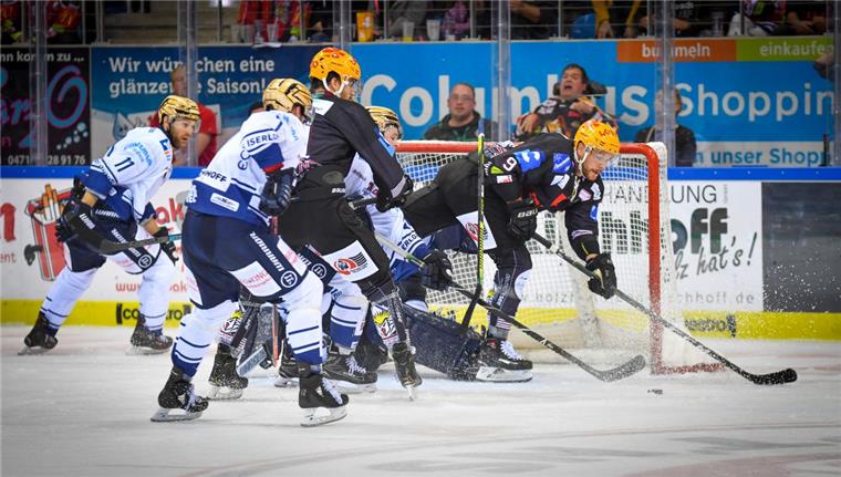 nord24 verlost Tickets für Pinguins-Heimspiel gegen Iserlohn Mehrere Eishockeyspieler kämpfen vor einem Tor um den Puck.