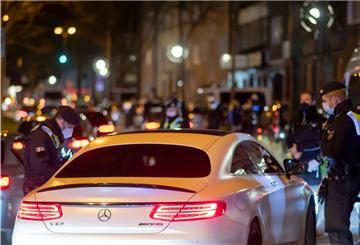 Polizisten überprüfen während einer Polizeikontrolle die Papiere eines Sportwagen-Fahrers.