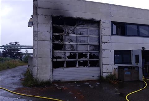 An dem Hallentor einer Metallbaufirma im Bremerhavener Fischereihafen sind deutliche Spuren des Brandes zu sehen. 
