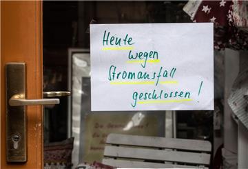 Ein Zettel "Heute wegen Stromausfall geschlossen!" hängt an der Tür eines Geschäftes.