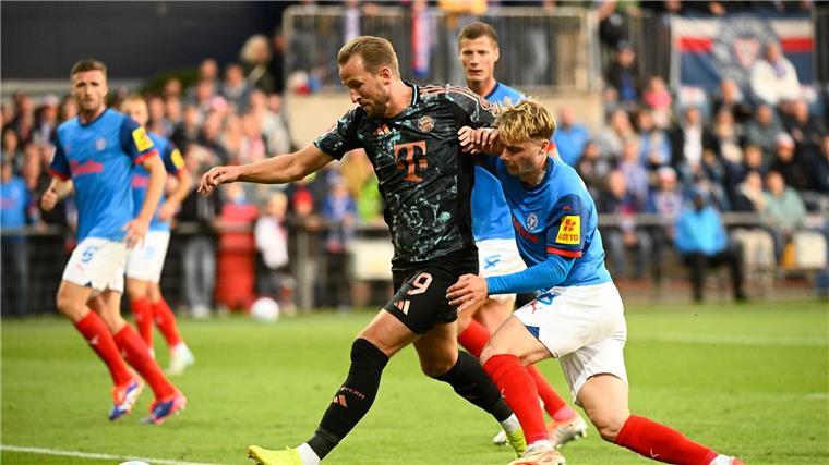 Bayern mit Tore-Show an die Spitze - Verlierer Goretzka Bayerns Harry Kane (l-r) behauptet den Ball gegen Kiels Finn Porath.