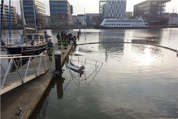 Begrenzt den Umweltschaden: Die Feuerwehr hat am Montagmorgen rund um die versunkene Motoryacht im neuen Hafen Ölsperren ausgelegt.