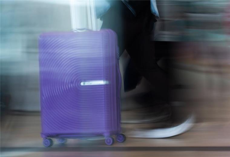 Ein Mann schiebt einen Koffer durch das Terminal vom Flughafen BER. In Neuseeland hat eine Frau ihre zweijährige Tochter in einen Koffer gepackt und im Gepäckraum eines Reisebusses verstaut.
