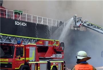 Beim Brand im Hafen setzt die Feuerwehr auch ihren Kran mit einem speziellen Löschrohr ein .