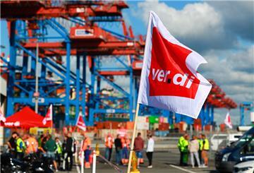 Beschäftigte mit Verdi-Flaggen protestieren am 14.07.2022 bei einem Warnstreik vor dem Container Terminal Burchardkai der HHLA (Hamburger Hafen und Logistik AG).