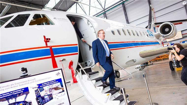Boris Pistorius (SPD) verlässt bei seinem Besuch vom Deutschen Zentrums für Luft- und Raumfahrt (DLR) ein Forschungsflugzeug in einem Hangar.