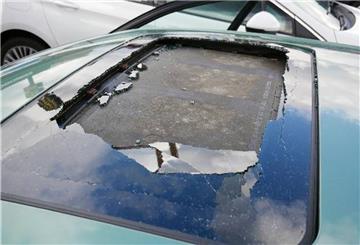 Das zerstörte Glasschiebedach eines Autos: Ein noch unbekannter Mann wird gesucht, der am Sonntag von einer Autobahnbrücke an der A1 einen Gegenstand auf die Fahrbahn geworfen hat.