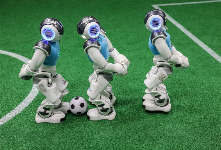 Drei Nao-Roboter spielen Fußball 