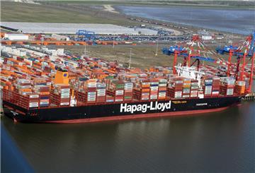 Ein riesiges Containerschiff liegt im Hafen. 