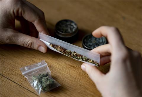  Eine Person dreht sich einen Joint. 