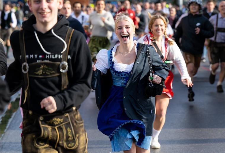 Die ersten Wiesnbesucher rennen nach dem Einlass zu den Festzelten.