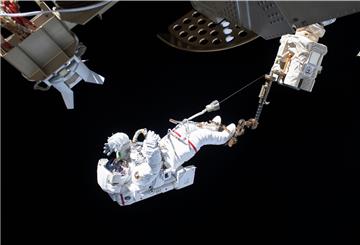 Der ESA-Astronaut Luca Parmitano ist bei einem Außeneinsatz an der Internationalen Raumstation ISS über den Roboterarm Canadarm2 gesichert. 