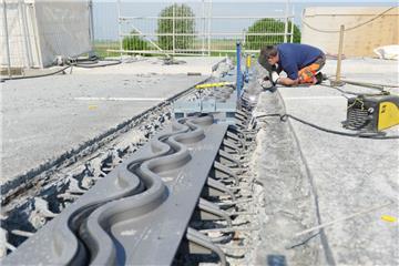 Die neue Lunebrücke in Bremerhaven muss bereits saniert werden. Frank Zeller fixiert die neue Fahrbahn-Übergangskonstruktion mit ein paar Schweißpunkten. Die geschwungene Dehnungsfuge ist besonders geräuscharm, und lässt bei Hitze oder Kälte bis zu 95 Millimeter Bewegung des Stahlbetons zu.