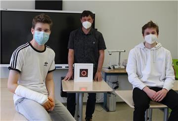 Die Neuntklässler Finn Pohle (15, links) und Erik Habermann (14, rechts) haben CO2-Ampeln entwickelt, die nun im Gymnasium Langen zum Einsatz kommen. Lehrer Steffen Mitgau freut sich über das Engagement seiner Schüler.