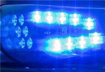 Das Blaulicht auf einem Fahrzeug der Polizei leuchtet in der Dunkelheit.