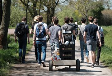  Eine Gruppe junger Männer feiert den Vatertag mit einem mit Bier gefüllten Bollerwagen. 