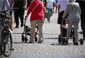 Seniorinnen gehen jeweils mit ihrem Rollator durch die Leipziger Innenstadt.