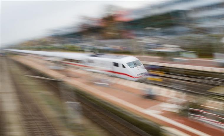 Bremerhaven will weiterhin zurück ans ICE-Netz Ein weißer Zug rast durch einen Bahnhof.