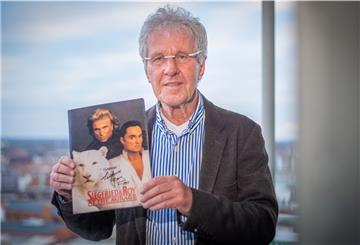 Dieter Bücking hält ein Erinnerungsstück an die Magier Siegfried und Roy in die Kamera: ein Magazin mit einer persönlichen Widmung der Weltstars.