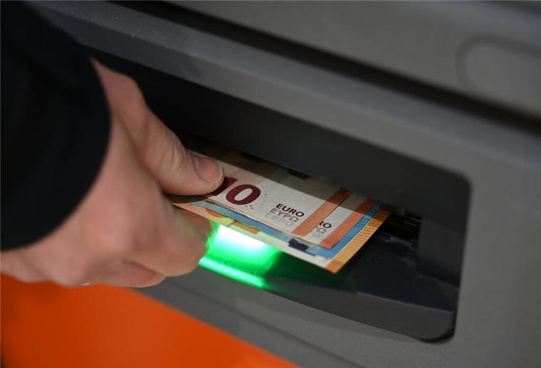 Bargeld ade? Warum viele Bürgergeld-Empfänger jetzt schnell handeln müssen Ein Mann zieht Geldscheine aus dem Ausgabefach eines Geldautomaten