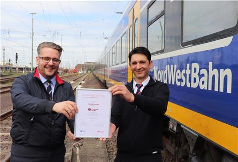 Eduard Skura (rechts) bekommt die Auszeichnung für den Landessieg von Robert Palm, Regionalleiter der Regio-S-Bahn Bremen/Niedersachsen überreicht.