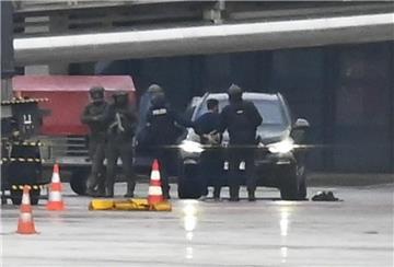 Ein Mann wird auf dem Flughafen Hamburg von der Polizei weggeführt.