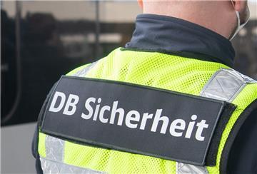 Ein Mitarbeiter der DB-Sicherheit wartet an einem einfahrenden ICE.