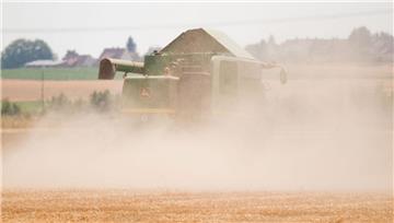 Ein Mähdrescher erntet ein staubtrockenes Feld in Niedersachsen. 