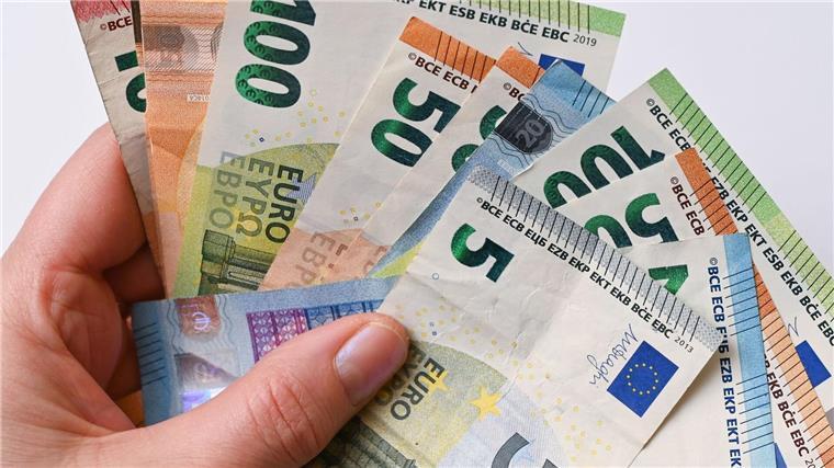 Noch rund 50.000 Rückzahlungen von Corona-Soforthilfen offen Eine Frau hält Geldscheine in der Hand.
