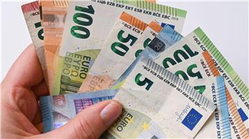 Eine Frau hält Geldscheine in der Hand.