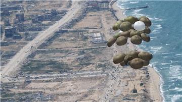 Fallschirme mit Lebensmitteln schweben nach dem Abwurf aus einer Transportmaschine der Luftwaffe über dem Gazastreifen.
