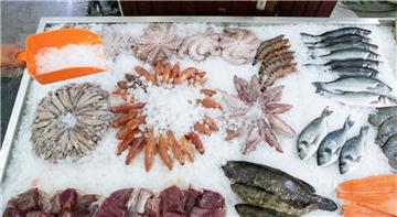 Frischer Fisch und andere Meeresfrüchte liegen auf einem Verkaufstisch im Fischmarkt Hamburg Altona. 