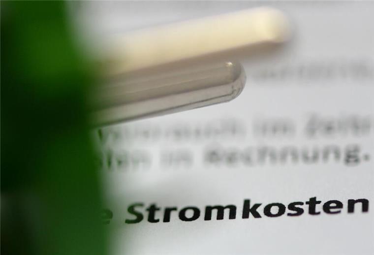 Neue Änderung bei Preisen für Strom und Gas: So viel zahlst du jetzt wirklich Ein grüner Stromstecker liegt auf einer Stromrechnung.