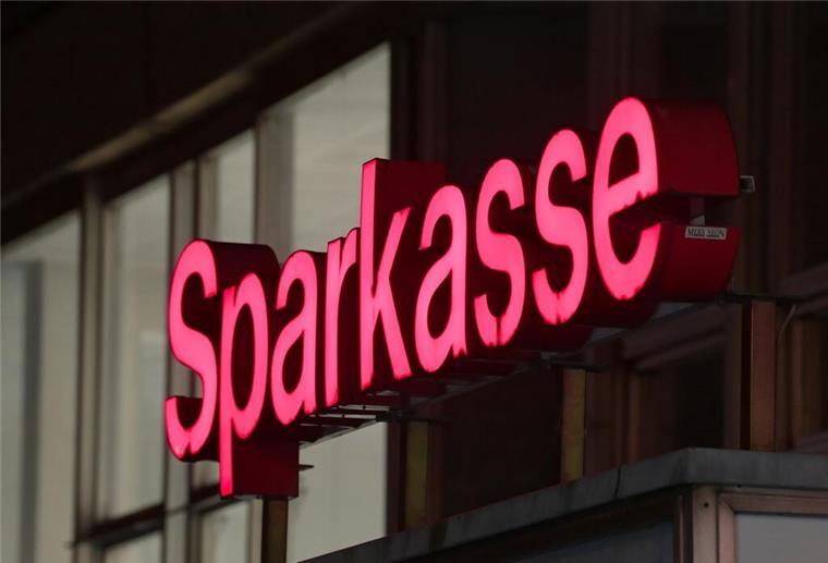 Der rote Schriftzug "Sparkasse" ist über dem Eingang zu einer Filiale zu sehen. Geld gibt es eigentlich nie geschenkt. Wer schnell ist und die Voraussetzungen erfüllt, kann nun aber mehrere Hundert Euro von der Sparkasse bekommen.