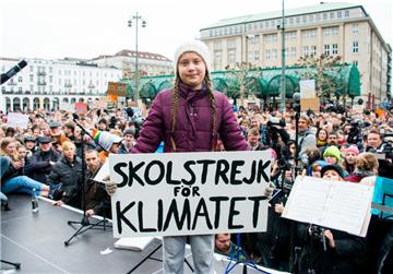 Greta Thunberg, Klimaaktivistin, steht während einer Kundgebung in Hamburg auf dem Rathausmarkt mit einem Transparent auf einer Bühne. Die junge Schwedin ist erstmals für einen Schulstreik für mehr Klimaschutz nach Deutschland gekommen.