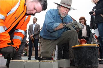 Handarbeit: Künstler Gunter Demnig (rechts) verlegt mit Bauhof-Mitarbeiter Thiemo Blanck (links) die Stolpersteine in Beverstedt.  