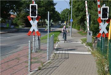Hans Kist überquert mit seinem Fahrrad den Bahnübergang im Verlauf der Kivinanstraße.