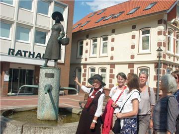 Heike Windus alias Mathilde ut Beers erklärt das Denkmal der "einkaufenden Hausfrau" Mathilde ut Beers.