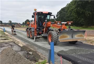 Das Foto zeigt eine Baumaschine im neuen Baugebiet. 