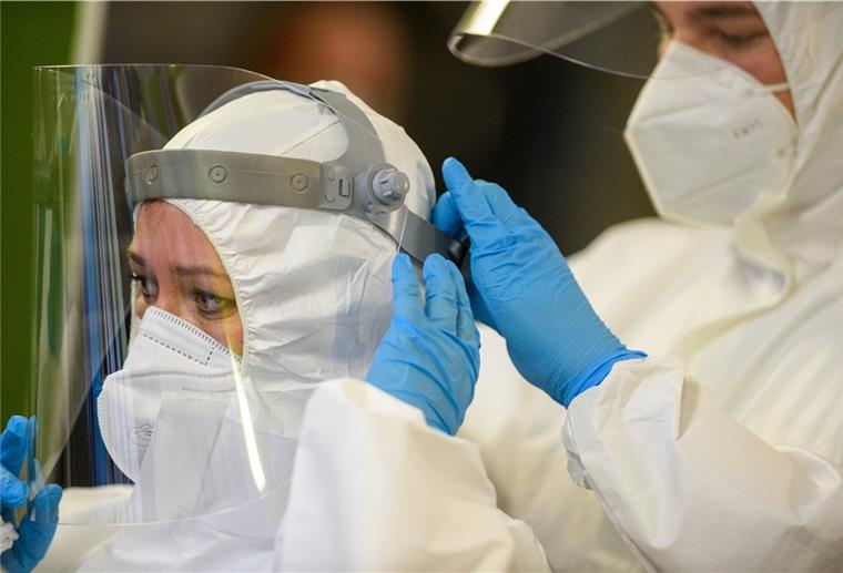 Coronavirus: Südafrika-Variante in Deutschland entdeckt Mitarbeiter des Universitätsklinikums Magdeburg bereiten sich auf den Start der Coronatests vor und helfen sich gegenseitig beim Anlegen der Schutzausrüstung.