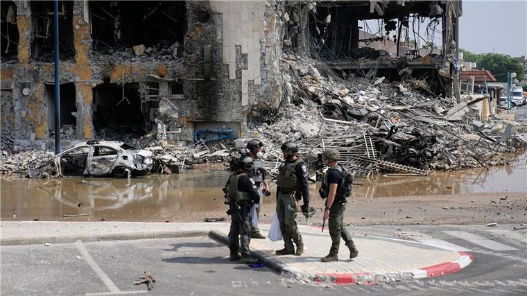 Israelische Polizisten stehen vor einer zerstörten Polizeistation.