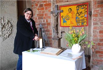 Jeden Morgen zündet Anja Niehoff an dieser Stelle unterm Kirchturm eine Kerze an. Die neue Pastorin hat ein Buch ausgelegt, in das Gemeindeglieder ihre Gedanken und Gebete eintragen können - und die müssen nicht unbedingt mit Corona zu tun haben.
