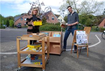 Kita to go: Bücher und Spiele stehen auch in Drangstedt zum Abholen bereit. Iris Dittmann, zuständige Fachbereichsleiterin bei der Stadt Geestland, und Kitaleiter Daniel Altenbeck freuen sich auf die jungen Nutzer. Foto Schoener