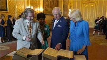 König Charles III. und Königin Camilla betrachten das erste Shakespeare-Folio während eines Empfangs auf Schloss Windsor.