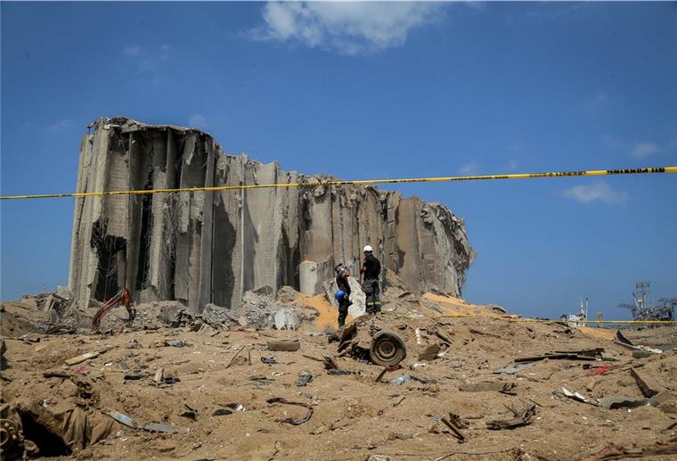 16 Hafenmitarbeiter nach Explosion in Beirut festgenommen Libanesische Zivilschutzhelfer stehen am Ort der verheerenden Explosion im Hafen der libanesischen Hauptstadt. Nach der schweren Detonation wird weiterhin nach Opfern und Überlebenden gesucht.