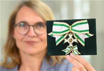 Maike Liebschner, Protokollchefin der Sächsischen Staatskanzlei hält den Verdienstorden des Freistaates Sachsen in der Damenausführung in der Hand. 