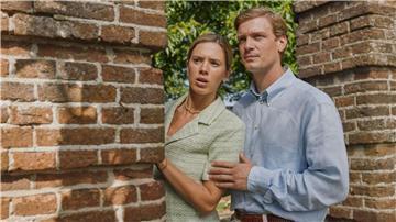 Máxima (Delfina Chaves) und Willem-Alexander (Martijn Lakemeier) verstecken sich hinter einem Mauervorsprung, Szene aus der Serie „Máxima“, die schon bei RTL+ zu sehen war und nun im frei verfügbaren TV bei ZDFneo läuft.