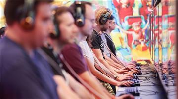 Messebesucher der Computer- und Videospielemesse „Gamescom“ testen ein Computerspiel.